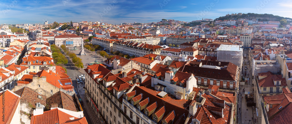 Panoramic view of Figueres Square, houses with red tiled roofs and Sao Jorge Castle on a hill in Lisbon, Portugal
