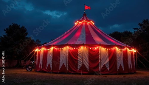Classic red & white striped carnival tent, illuminated at night , bright, red