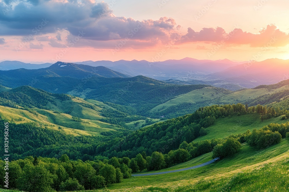 Naklejka premium Panoramic sunset view over rolling green hills and mountains.