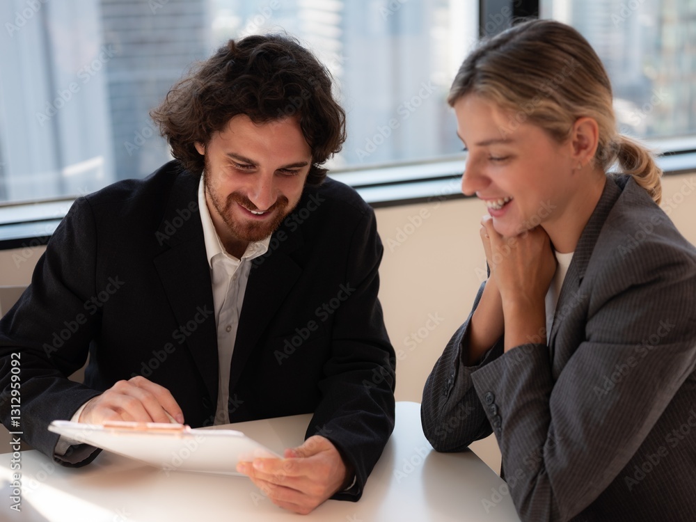 Businessmen collaborating on paperwork in modern office