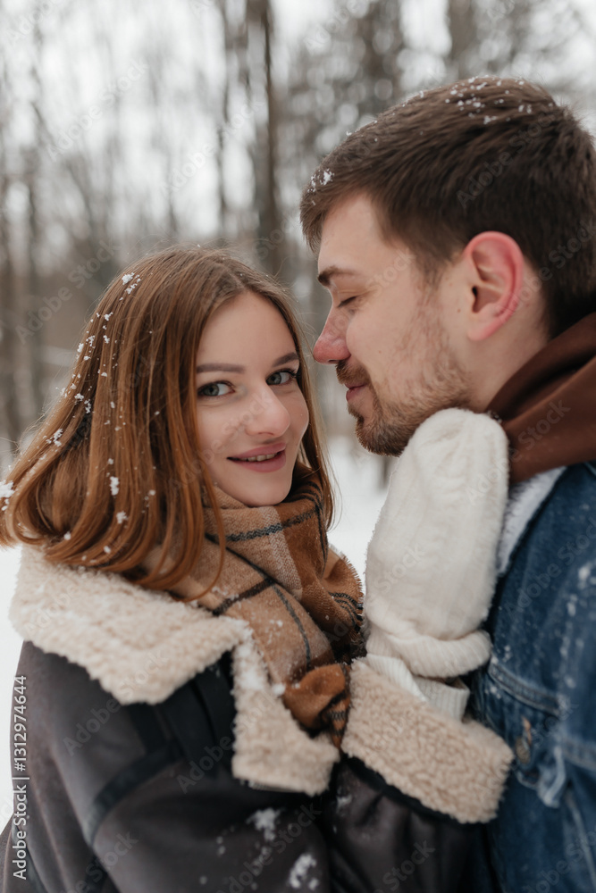 A couple joyfully embracing in a snowy winter wonderland, surrounded by natures beauty A couple joyfully embracing in a snowy winter wonderland, surrounded by natures beauty
