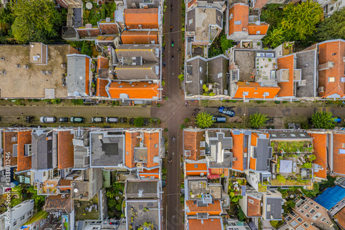Aerial view of Amsterdam, Netherlands showcases its iconic canal houses, Dutch architecture, and boat tours along the waterfront, capturing the charm of this historic European cityscape