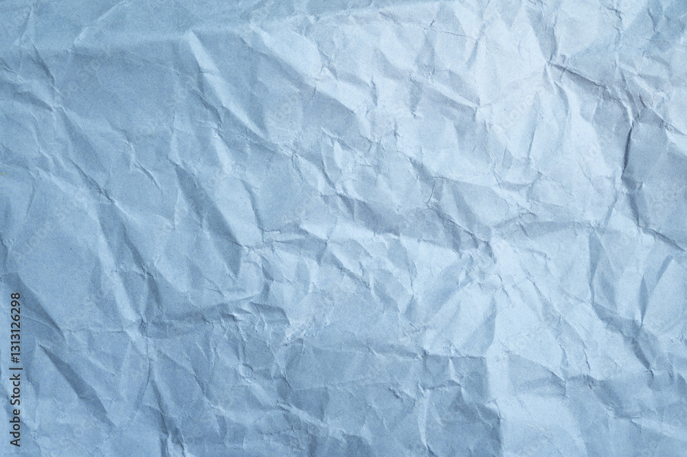 Fototapeta premium Full frame shot of crumpled light blue paper sheet texture and background.