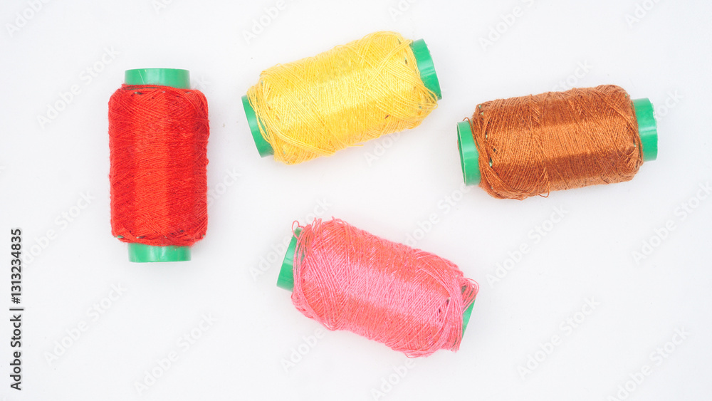 Different colors of sewing threads reels isolated on white background Different colors of sewing threads reels isolated on white background