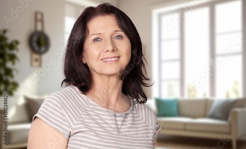 Head shot of happy old woman posing at home