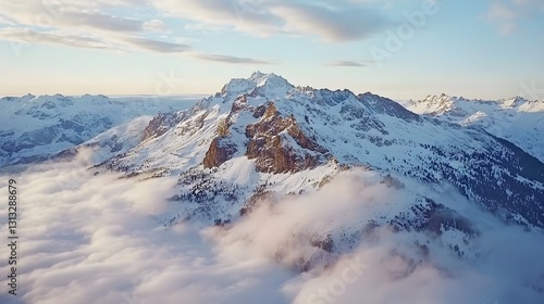 Majestic Winter Mountain Peak Soaring Above Cloudscape at Sunrise
