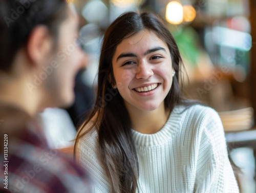 Wallpaper Mural "Smiling girl in white sweater looking at conversation partner in bright cafe" Torontodigital.ca