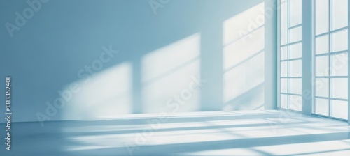 Bright and airy minimalist interior space with large windows casting soft shadows on a light-colored floor  ideal for artistic and architectural design projects