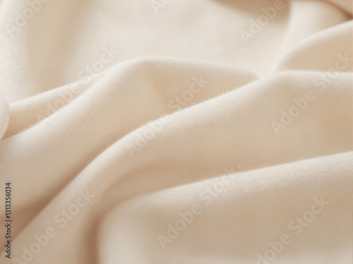 Close-up of soft, plush, light-colored fabric with gentle folds creating depth and texture.