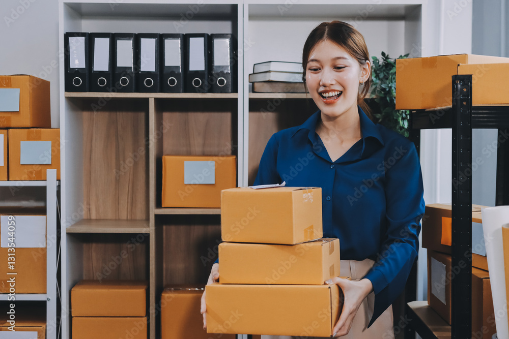 Fototapeta premium Asian SME business women use laptop computer checking customer order online shipping boxes at home. Starting Small business entrepreneur SME freelance. Online business, Work at home concept.