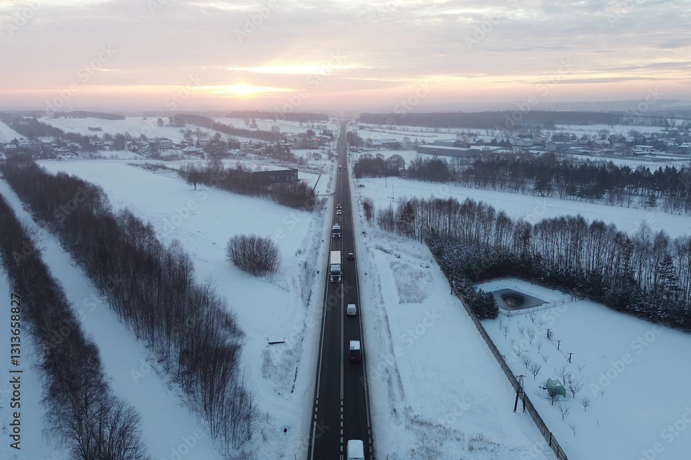 Sunset view of snowy road and forest Sunset view of snowy road and forest