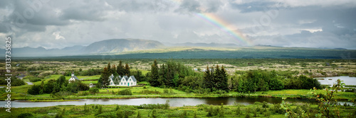 Panorama of Thingvellir National Park with a rainbow in summer, Iceland web banner