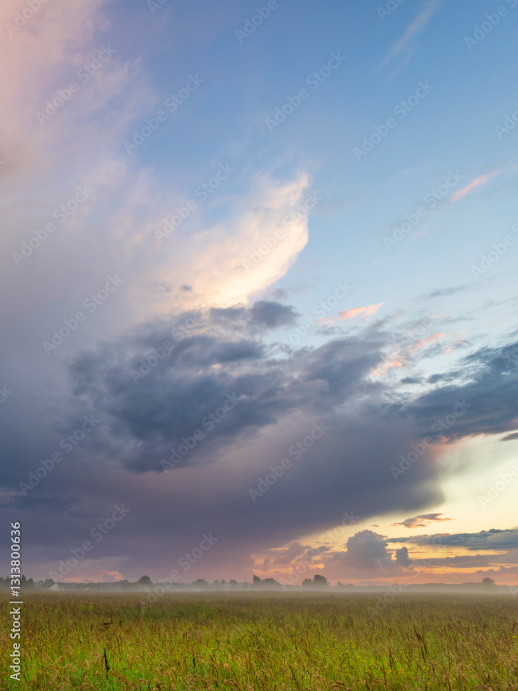 Cloudy sky with a large storm cloud in the middle Cloudy sky with a large storm cloud in the middle