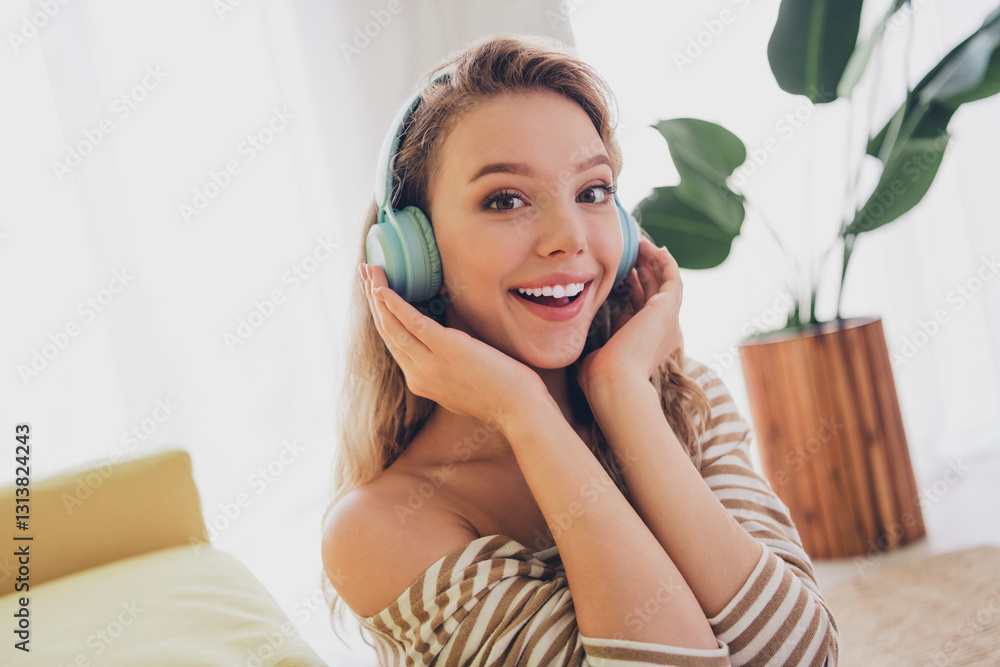 Young woman enjoying a relaxed weekend indoors with music and a bright smile Young woman enjoying a relaxed weekend indoors with music and a bright smile