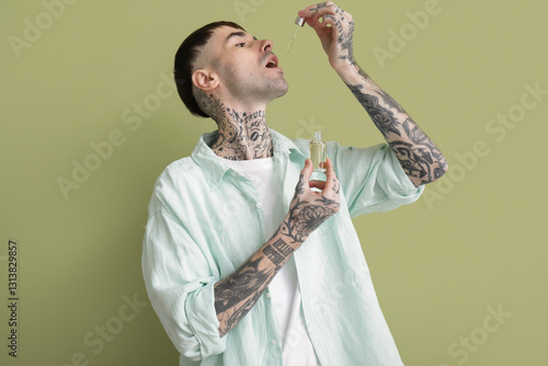 Young tattooed man taking C...