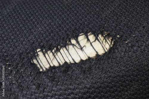 Worn spot in fabric of a foam seat cushion