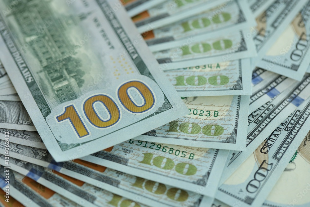 Many hundred dollar bills new banknotes in big pile under the natural light Many hundred dollar bills new banknotes in big pile under the natural light