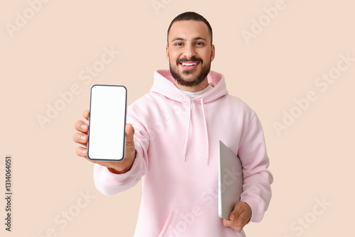 Young man with mobile phone...