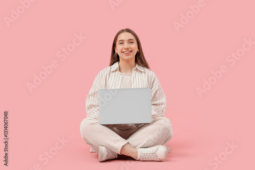 Young woman with laptop sit...