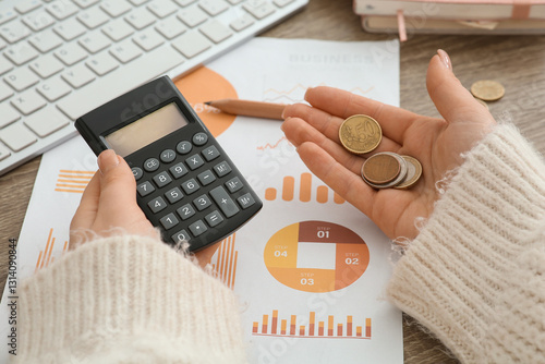 Woman holding coins and cal...