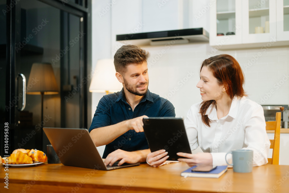 Modern couple collaborating over coffee in a cozy kitchen setting with a laptop, notebook, and breakfast. Modern couple collaborating over coffee in a cozy kitchen setting with a laptop, notebook, and breakfast.