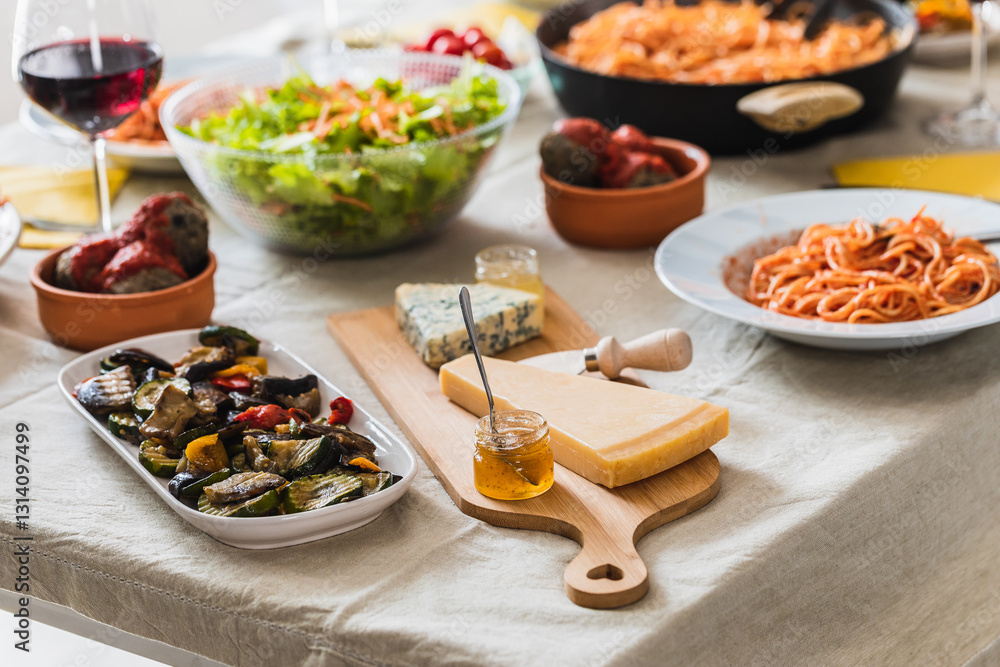 Italian lunch table setting featuring pasta, cheese, and vegetables Italian lunch table setting featuring pasta, cheese, and vegetables