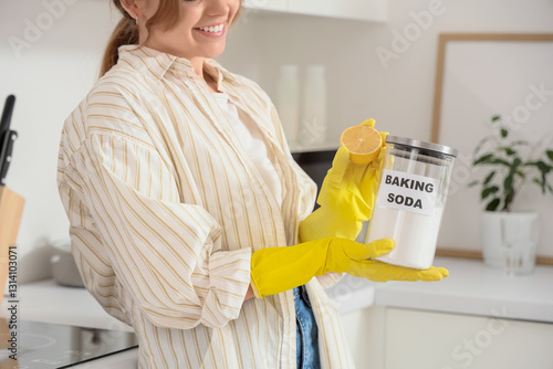 Bild auf Leinwand Young woman with jar of baking soda and lemon cleaning in kitchen, closeup