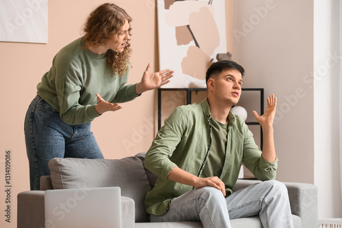 Angry wife scolding her hus...