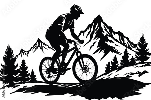 A man on a bike is riding down a hill with mountains in the background