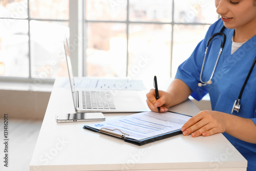 Female doctor filling out h...