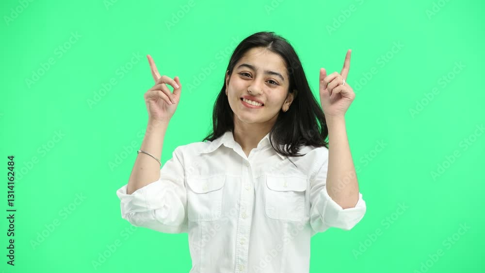 Woman, close-up, on a green background, pointing up Woman, close-up, on a green background, pointing up