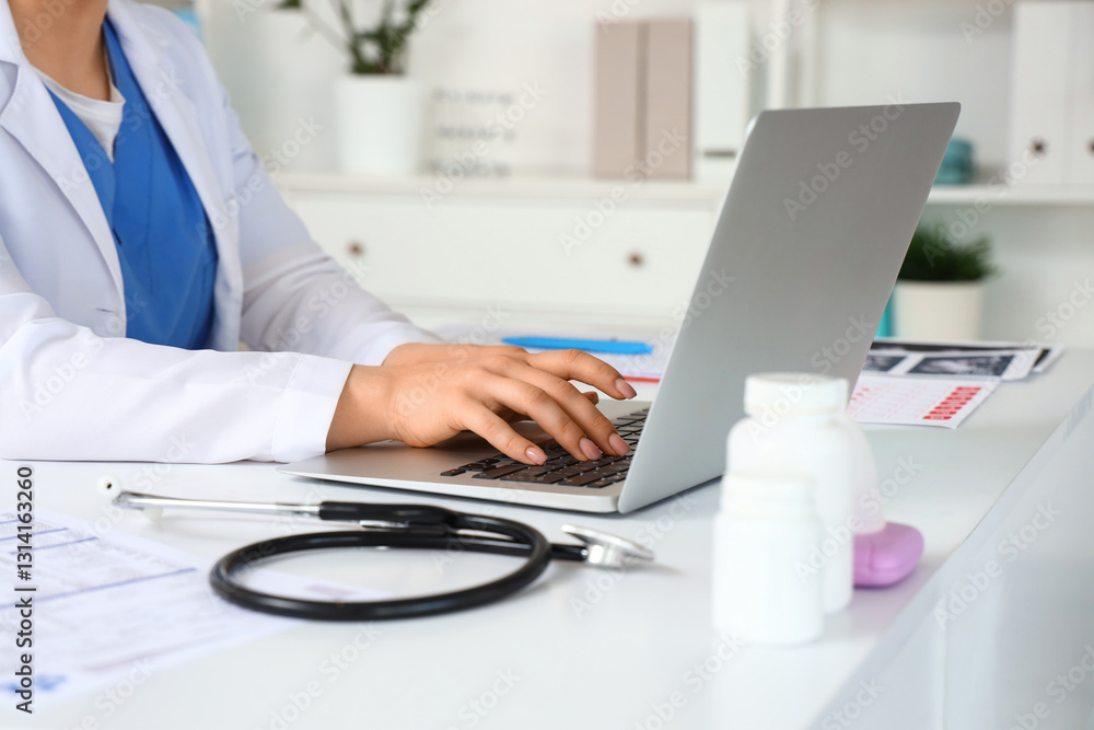 Female gynecologist working with laptop at desk in office, closeup Female gynecologist working with laptop at desk in office, closeup