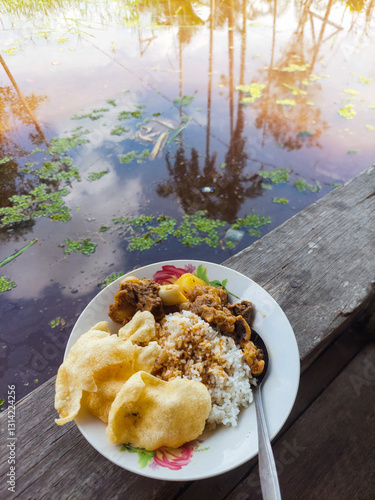 Home cooking, rice with beef and crackers on a plate on a terrace with a rural feel