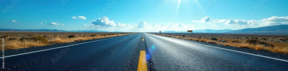 Naklejka premium Dark asphalt ribbon stretches to vanishing point under vast blue sky, path, freeway, winding road