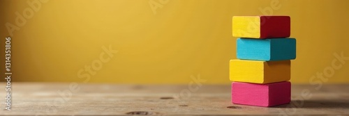 Stack of colorful wooden cubes on wooden background, hand-eye coordination, therapy