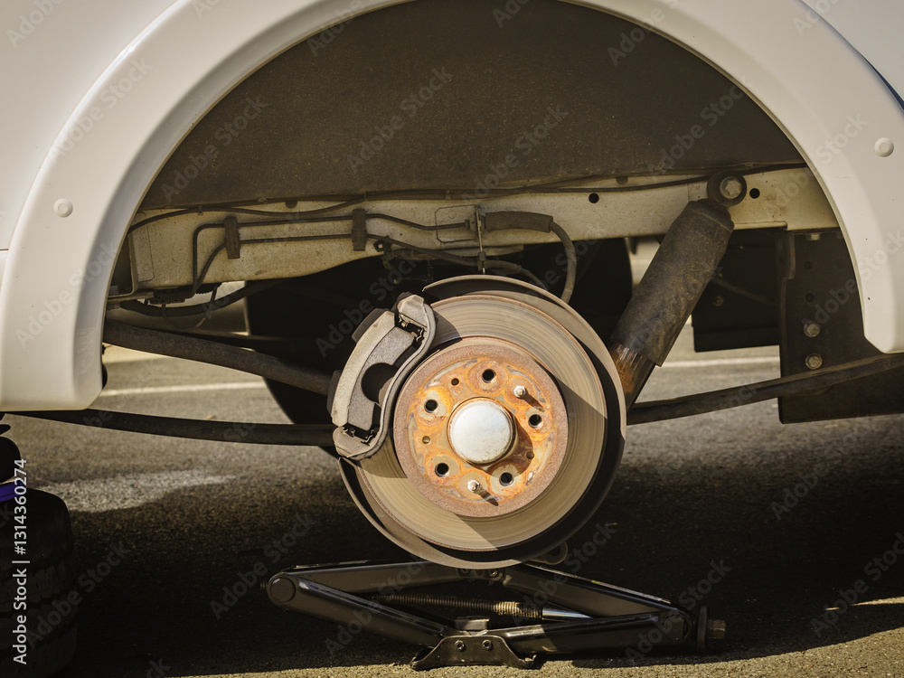 Car in service repairing. Detail of wheel assembly on automobile