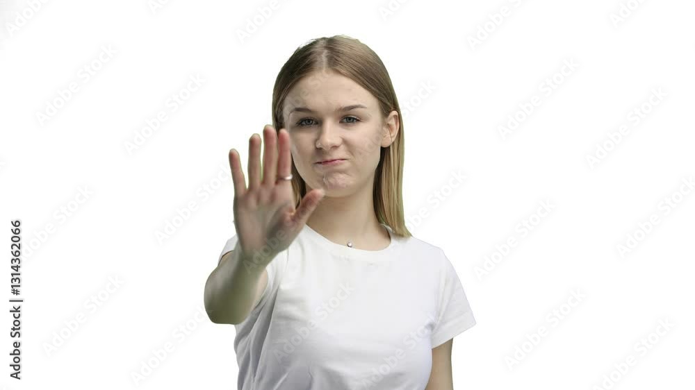 A woman, close-up, on a white background, shows a stop sign A woman, close-up, on a white background, shows a stop sign