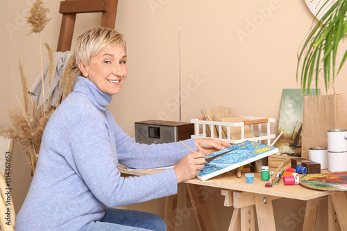 Mature female artist painti...