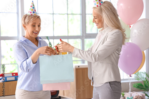 Mature woman receiving bags...