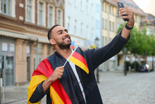 Young man with flags of Ger...