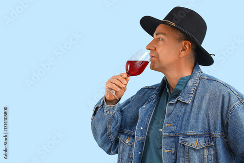 Mature man with glass of re...