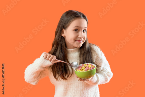 Cute little girl eating cer...