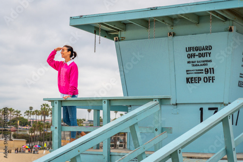 A lifeguard tower scene featuring an observer relaxing at the beautiful beach area in Santa Monica Beach, California