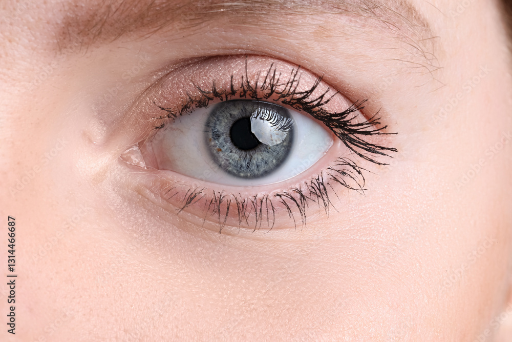 Obraz premium Young woman with beautiful blue eyes. Closeup