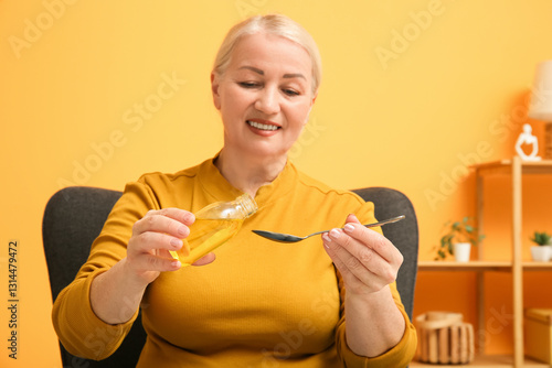 Mature woman pouring fish o...