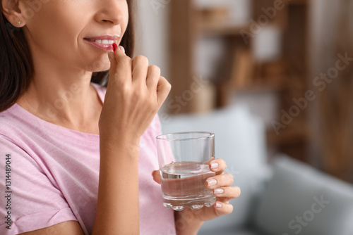 Beautiful woman taking medi...