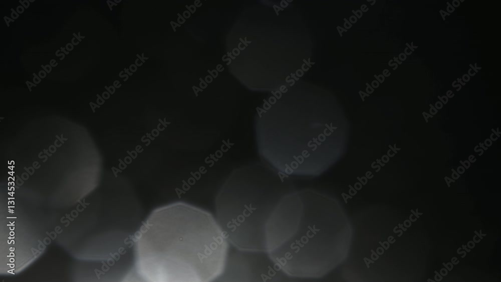 A mystical and mysterious atmosphere from the light of a flashlight on the front lens of the objective, where dust particles and water drops shimmer as bokeh in this light.