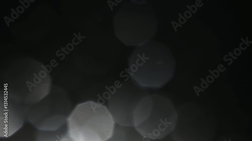 A mystical and mysterious atmosphere from the light of a flashlight on the front lens of the objective, where dust particles and water drops shimmer as bokeh in this light.