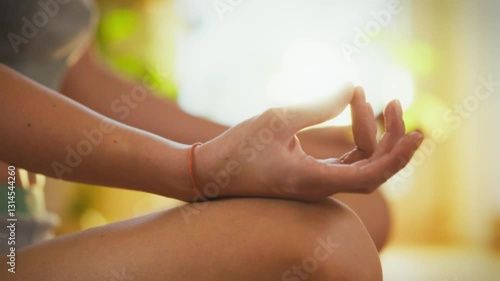 Wallpaper Mural A person practices meditation in a bright, sunlit room. Their hands are positioned in a mudra, promoting peace and mindfulness. This serene environment supports relaxation and clarity Torontodigital.ca