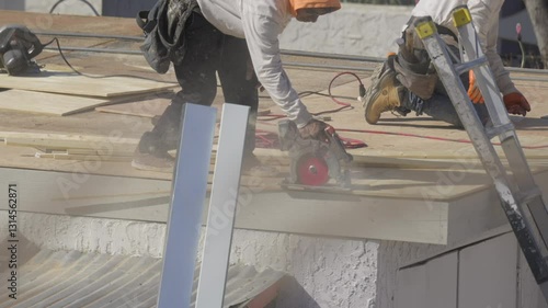 This video shows a roofer sawing through roofing material.